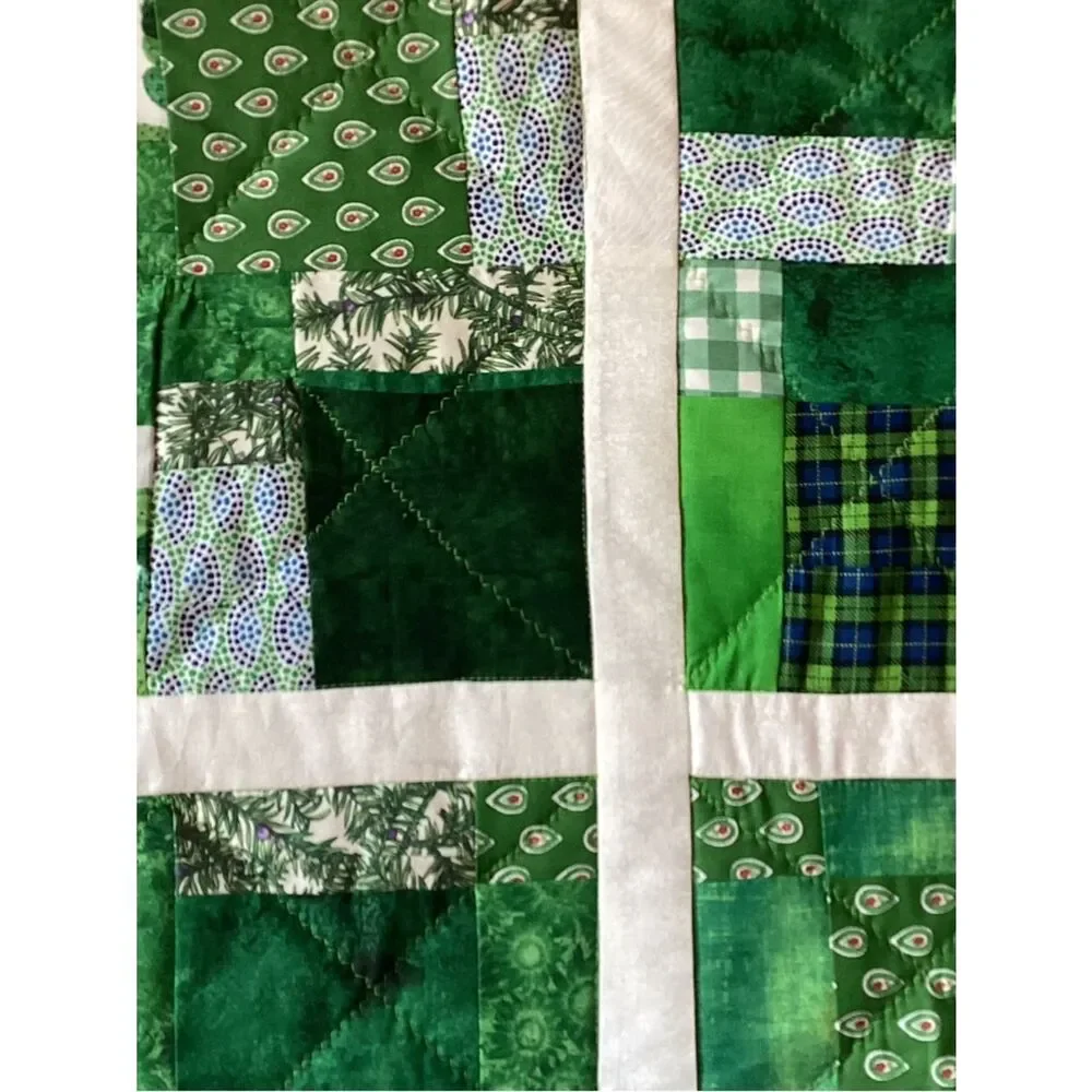 New without tags. Medley of Green Fabrics with White Borders Quilt